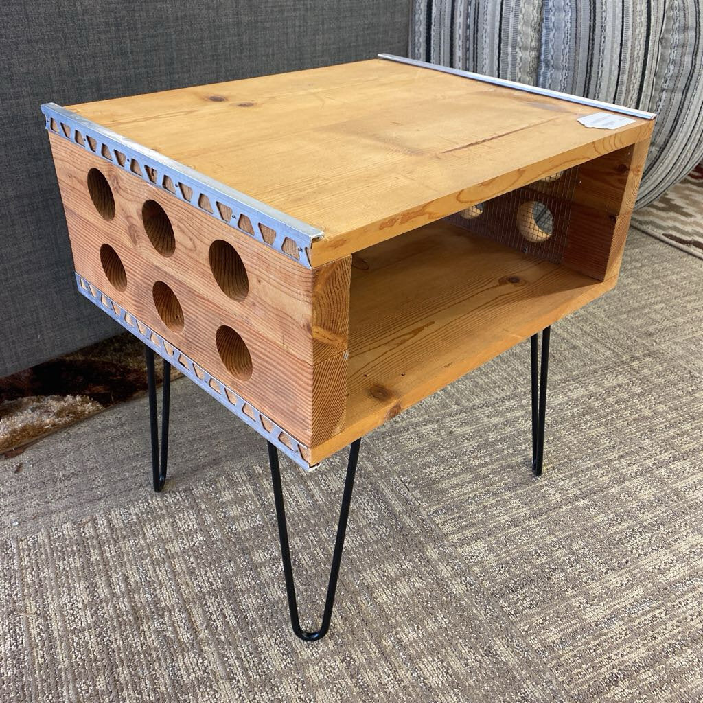 Wooden pet play area with holes on a carpeted floor