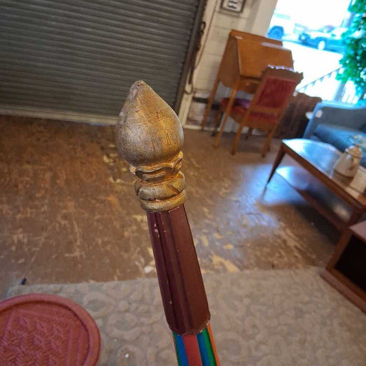 Decorative pencil with a gold ferrule in a room with furniture and decor.