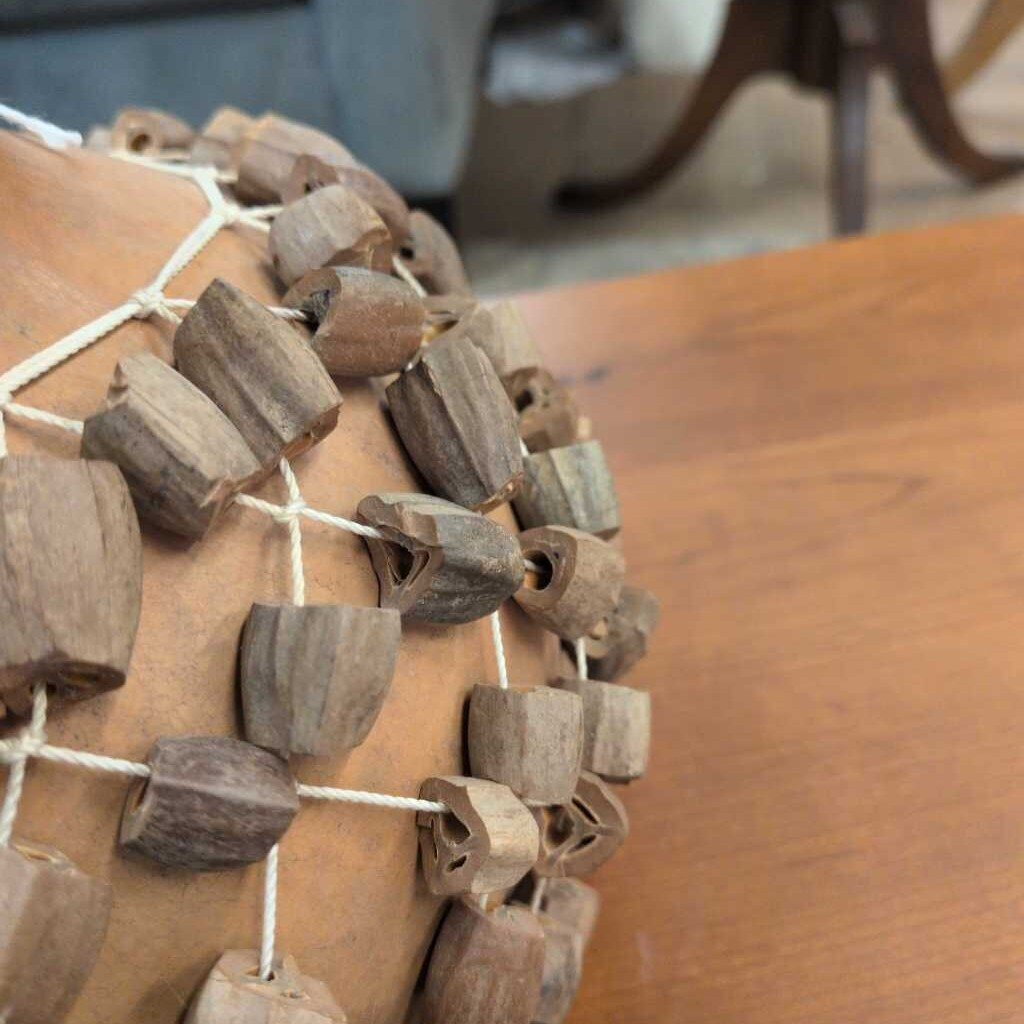 Wooden bead pattern on a textured surface