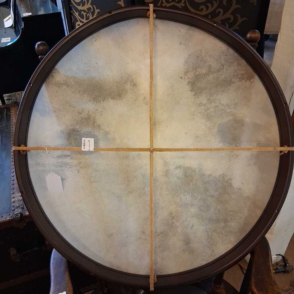 Large round drum with a textured surface and wooden frame.