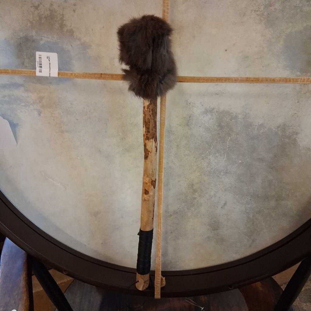 Duster with a fluffy head on a tiled floor