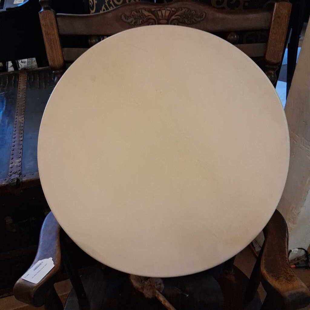 Round beige object on a chair with a blurred background