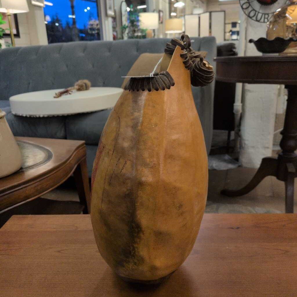 Decorative gourd with a brush on top in a store setting