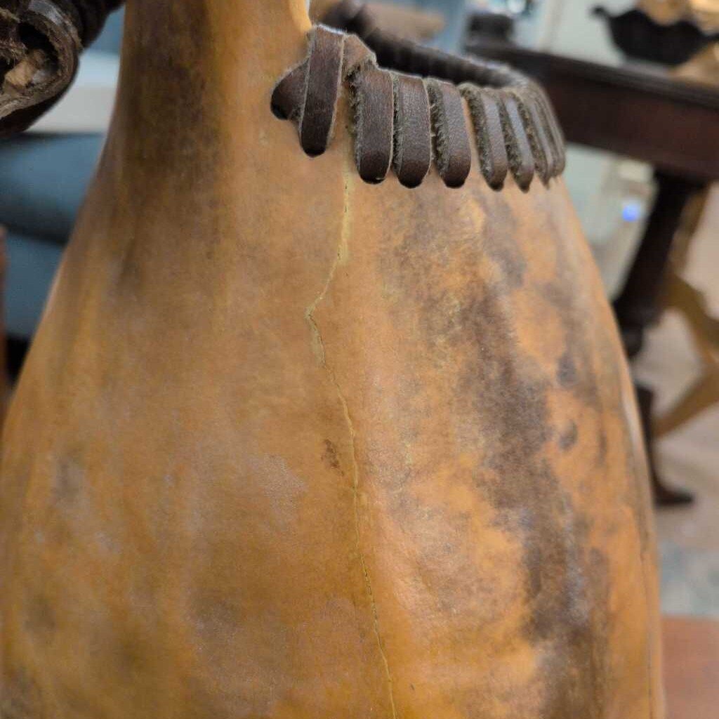 Close-up of a brown leather chair with metal accents