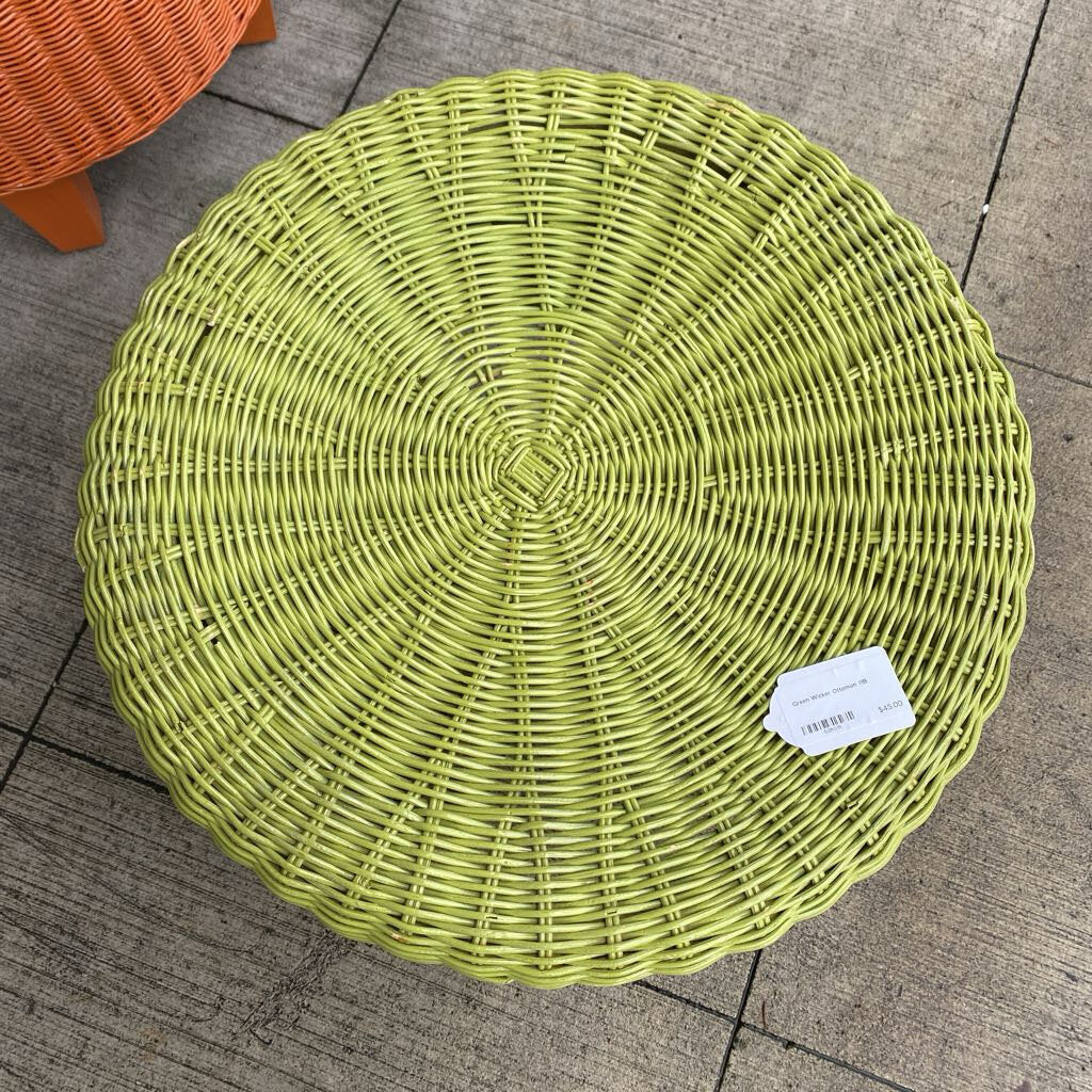 Round wicker stool with a label on a tiled floor