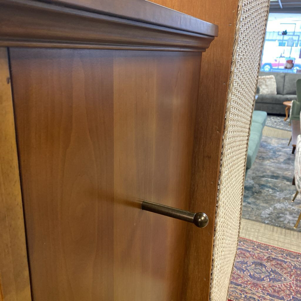 Wooden cabinet with a metal handle in a room setting
