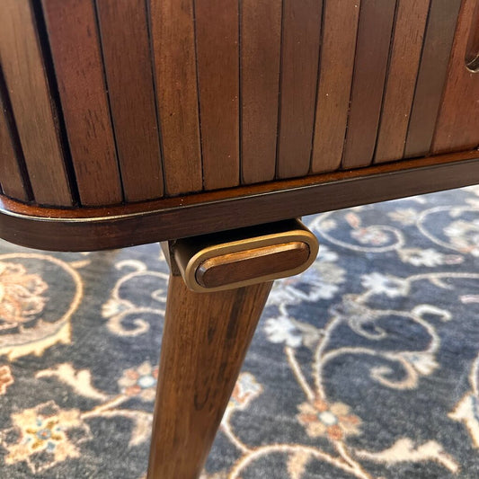 Wooden side table with slatted design on a patterned rug