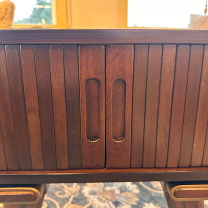Wooden cabinet with slatted design on a blurred background