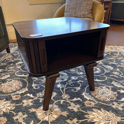Wooden side table with a shelf on a patterned rug