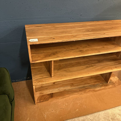 Wooden bookshelf against a blue wall