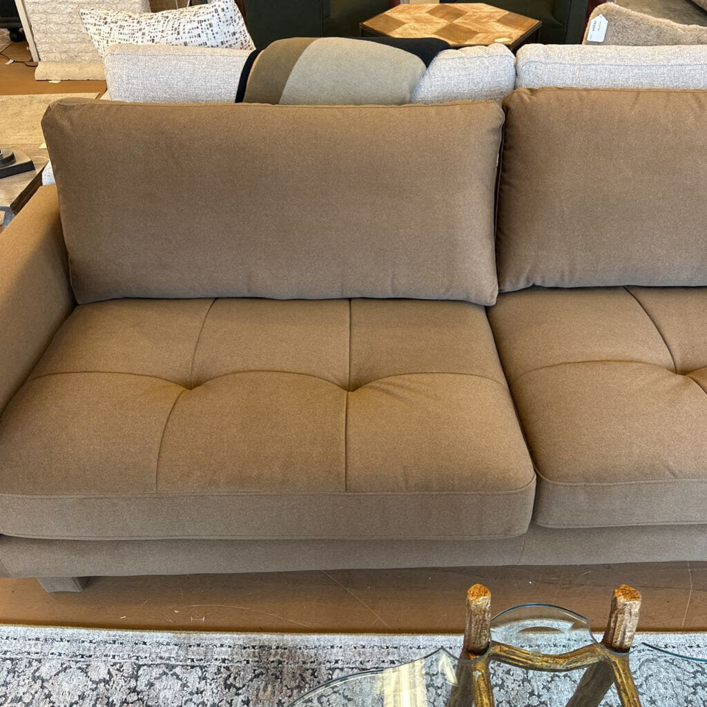 Beige sectional sofa in a showroom setting