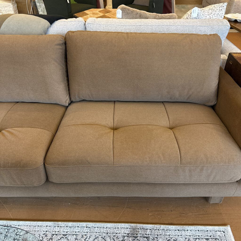 Beige sectional sofa in a living room setting