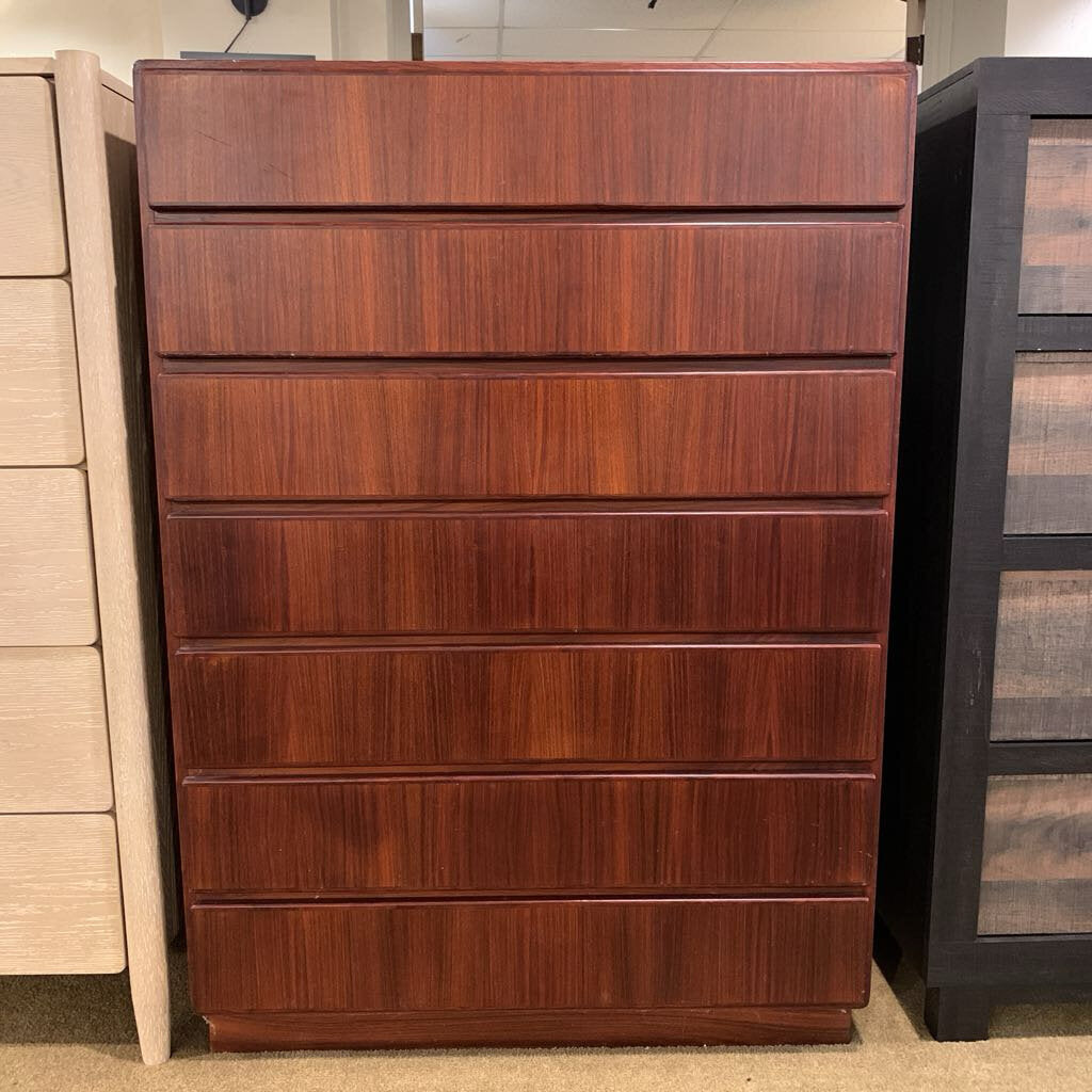 Wooden dresser with five drawers in a store setting