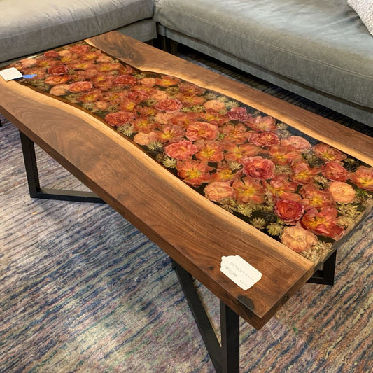 Wooden coffee table with floral design in a living room setting