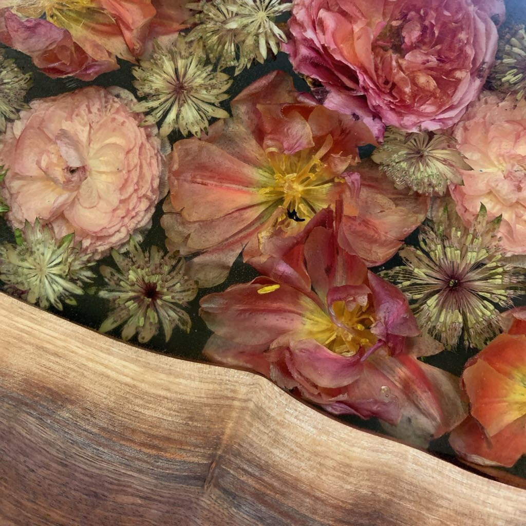 Close-up of colorful flowers with a wooden surface in the foreground
