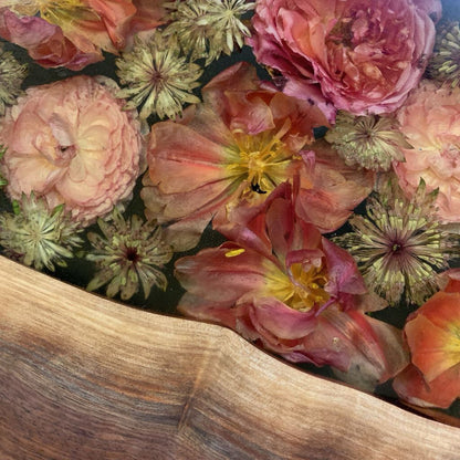 Close-up of colorful flowers with a wooden surface in the foreground