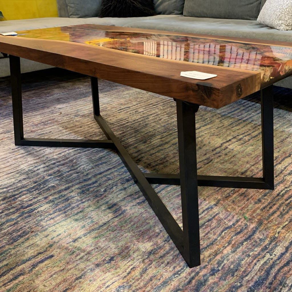 Wooden coffee table with metal legs on a patterned carpet