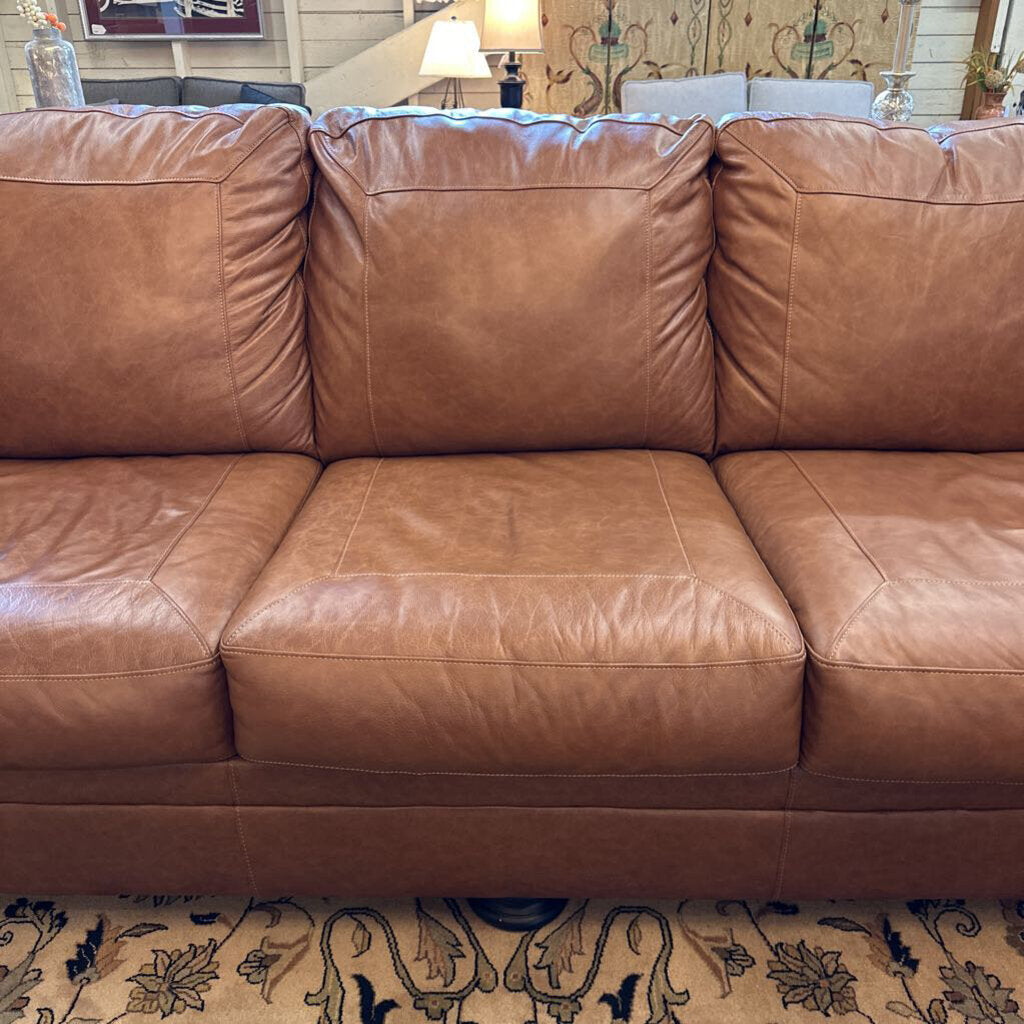 Brown leather sofa in a living room setting