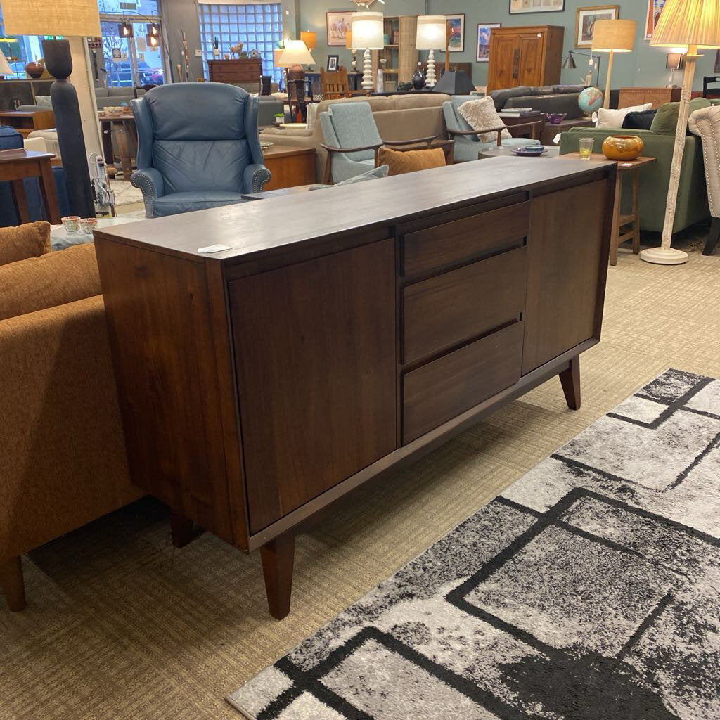 Wooden sideboard in a room with furniture and decor