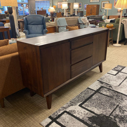 Wooden sideboard in a room with furniture and decor