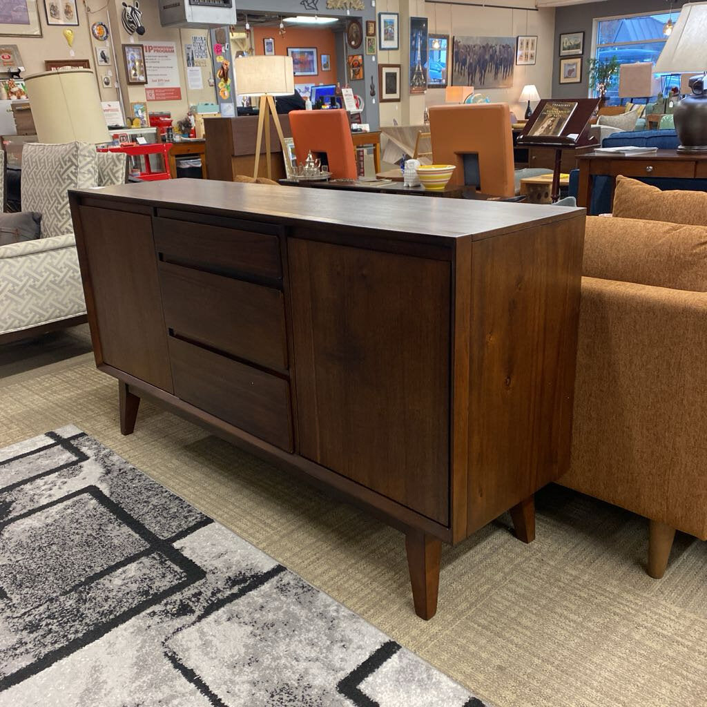 Wooden sideboard in a room with furniture and decor