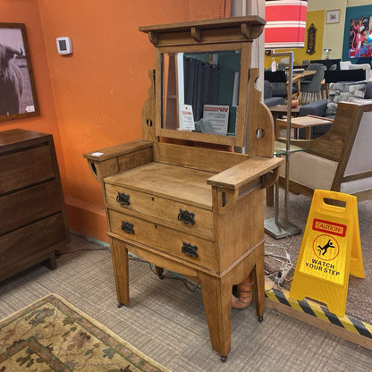Wooden vanity with mirror in a store setting with caution sign