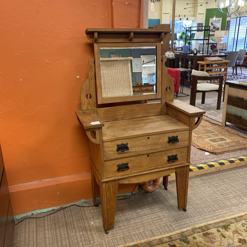 Wooden vanity with mirror in a store setting
