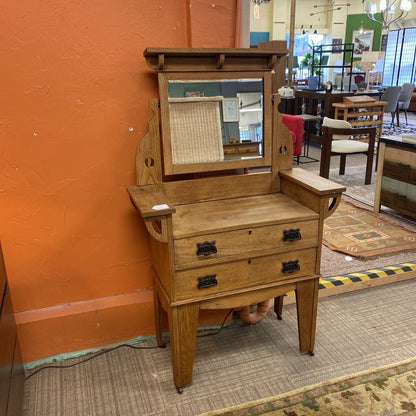 Wooden vanity with mirror in a store setting