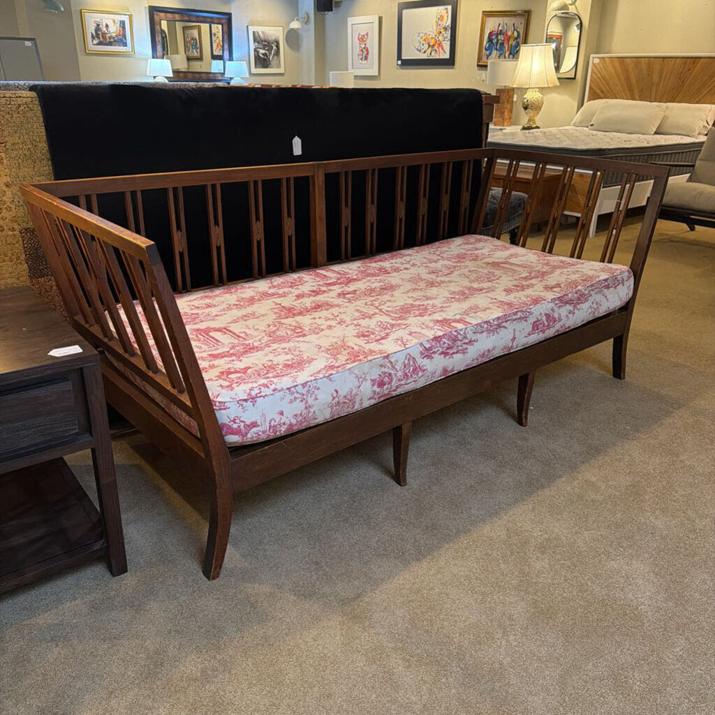 Wooden bench with floral cushion in a showroom setting