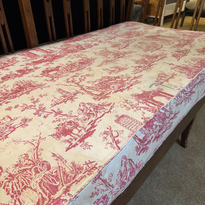 Tablecloth with pink and white floral pattern on a wooden table