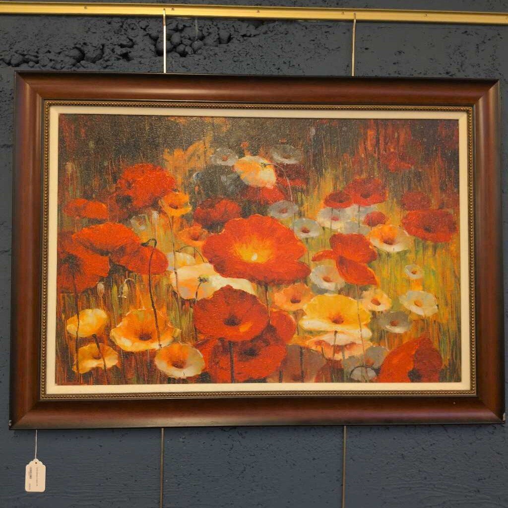 Framed painting of flowers on a textured wall