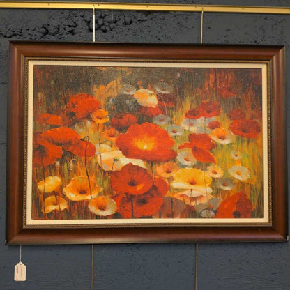 Framed painting of flowers on a textured wall