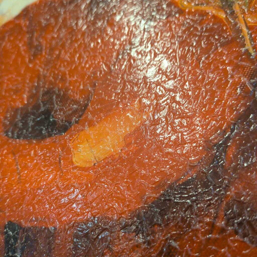 Close-up of a textured brown surface with a dark brown leaf