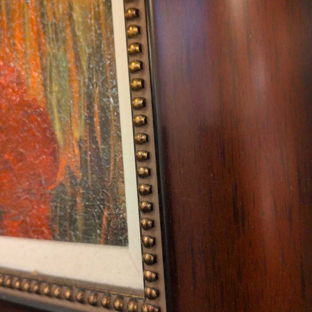 Close-up of a wooden frame with decorative nailhead trim