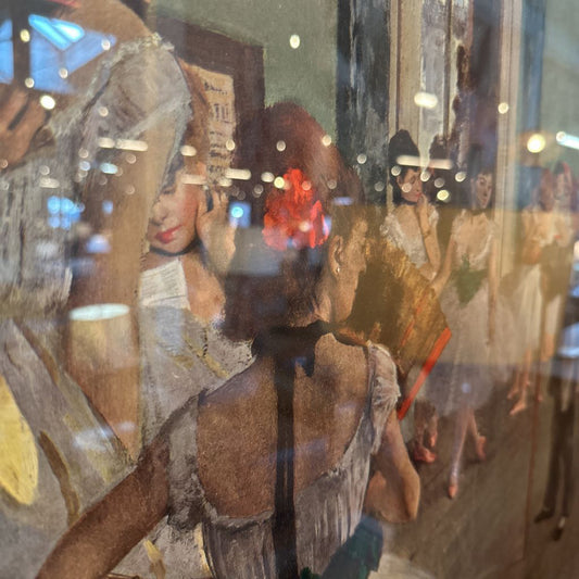 Vintage-style illustration of a woman with a red flower in her hair, surrounded by other women.