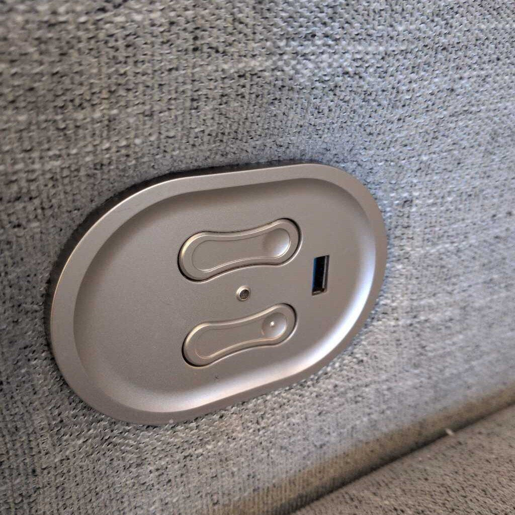 Car cup holder with USB charging port on a textured gray surface