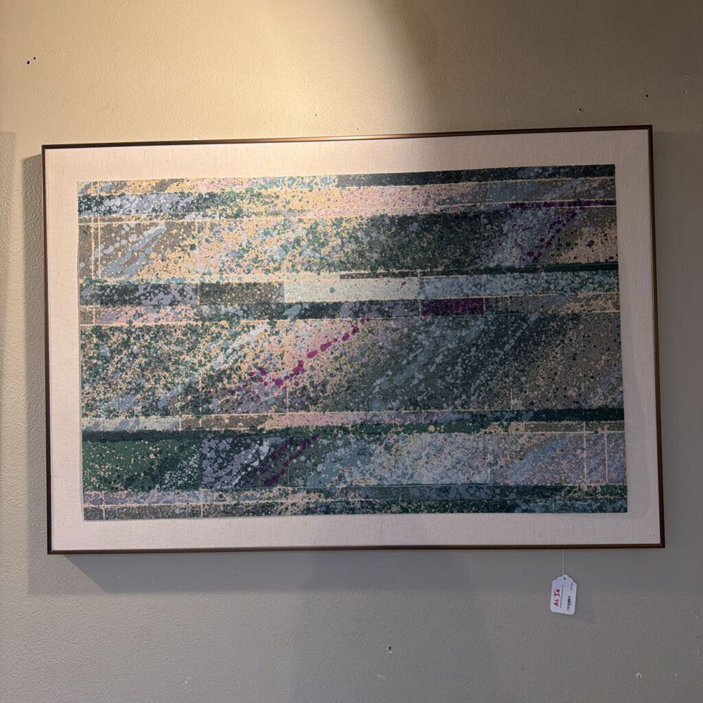 Framed abstract artwork on a wall with a visible price tag.
