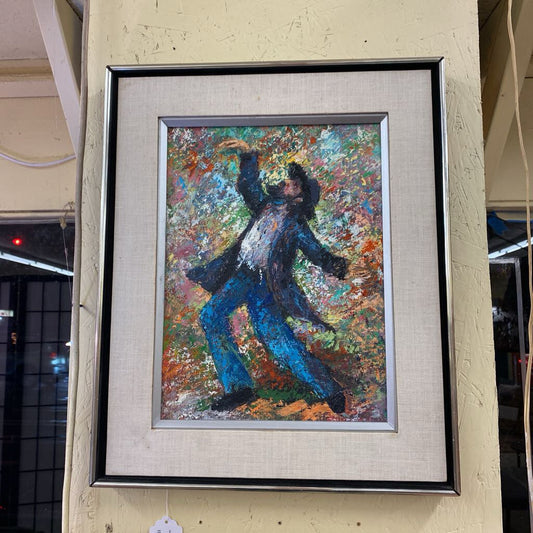 Framed painting of a person in a dynamic pose with a colorful abstract background.