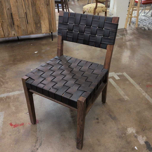 Chair with woven seat and backrest on a concrete floor