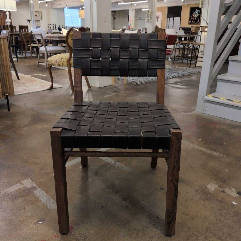 Chair with woven backrest and seat in a furniture store setting