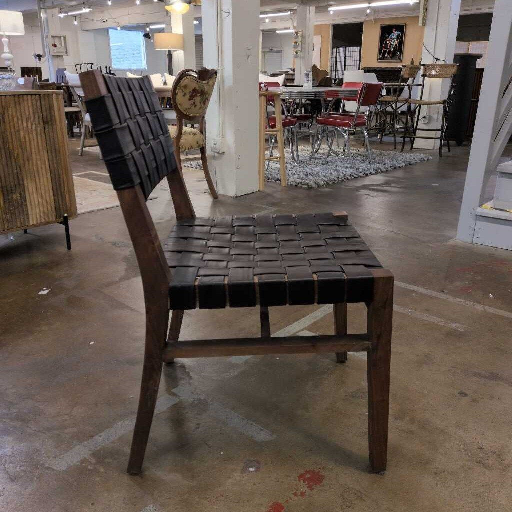 Wooden chair with woven backrest in a showroom setting