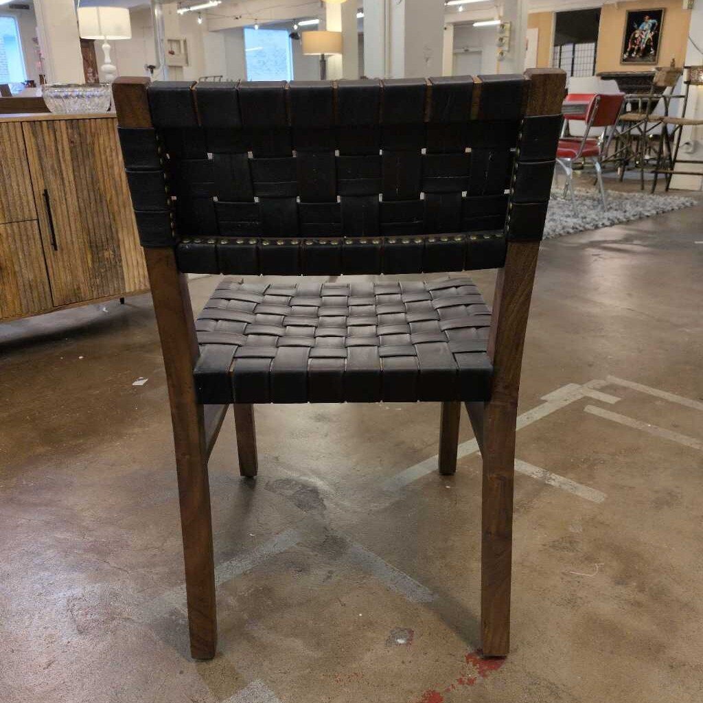 Chair with woven seat and backrest in a store setting