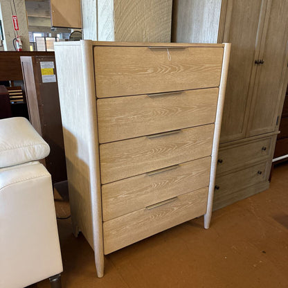 Wooden dresser with multiple drawers in a room setting