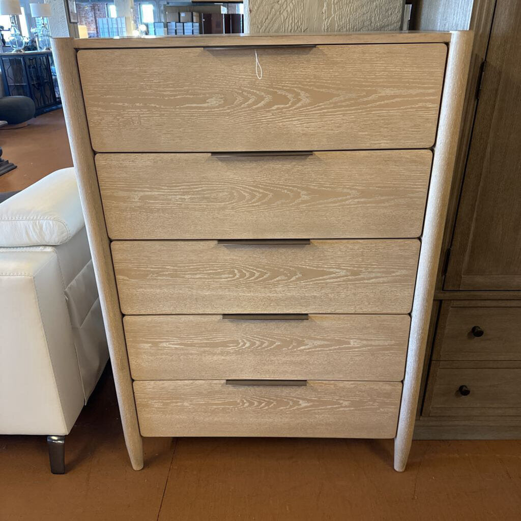 Wooden dresser with five drawers in a room setting