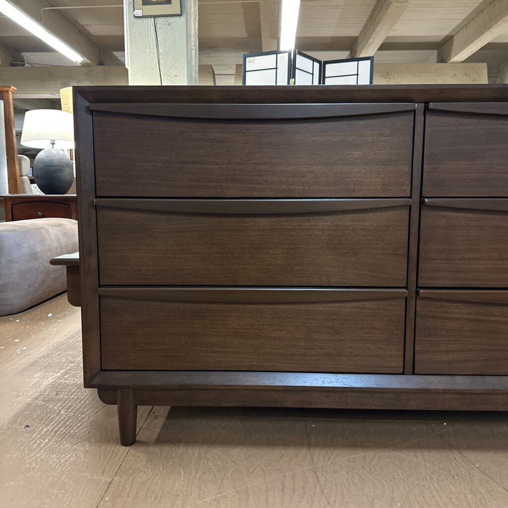 Wooden dresser with multiple drawers in a room setting