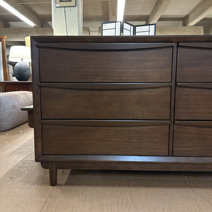 Wooden dresser with multiple drawers in a room setting
