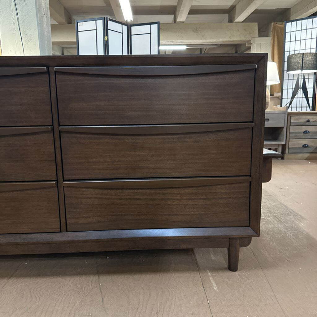 Wooden dresser with multiple drawers in a room setting