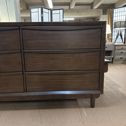Wooden dresser with multiple drawers in a room setting