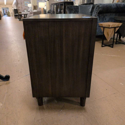 Dark wooden side table in a furniture store setting