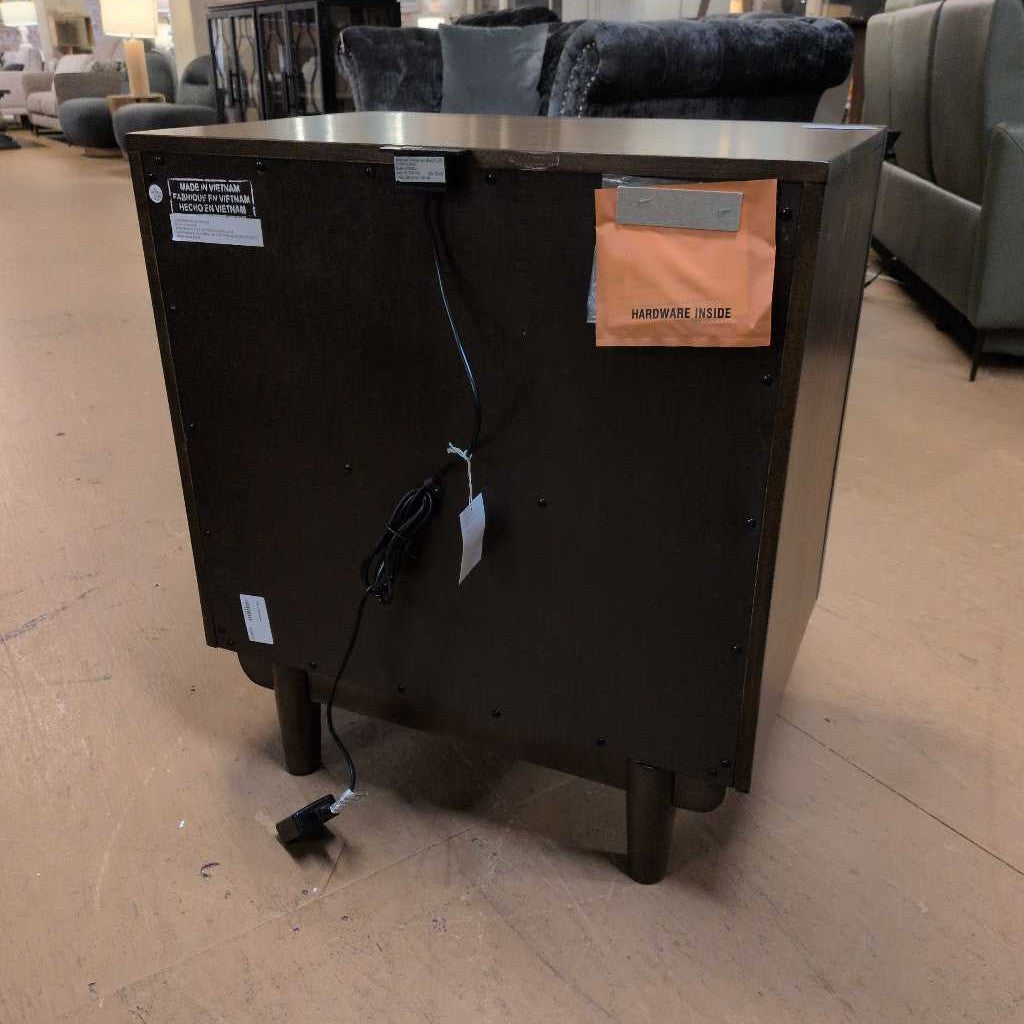 Black cabinet with tags on a beige floor in an indoor setting
